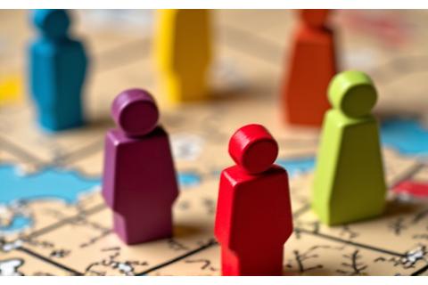 Meeples occupying spaces on a game board, illustrating worker placement.